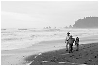 Family walking on Rialto Beach. Olympic National Park, Washington, USA. (black and white)
