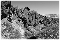 Hikers on rugged section of High Peaks trail. Pinnacles National Park, California, USA. (black and white)