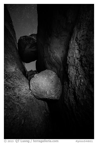 Boulders wedged in Balconies Cave at night. Pinnacles National Park (black and white)