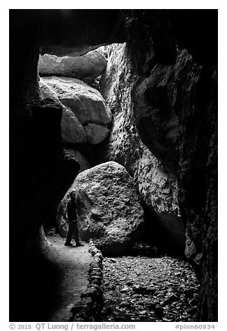 Hiker looking around Bear Gulch Cave. Pinnacles National Park (black and white)