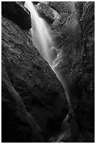 Waterfall spilling down from reservoir into Bear Gulch Cave. Pinnacles National Park ( black and white)