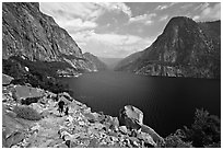 Father hiking with boy next to Hetch Hetchy reservoir. Yosemite National Park, California, USA. (black and white)