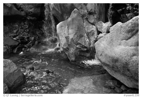 Children swimming in pool at the base of Wapama falls. Yosemite National Park (black and white)