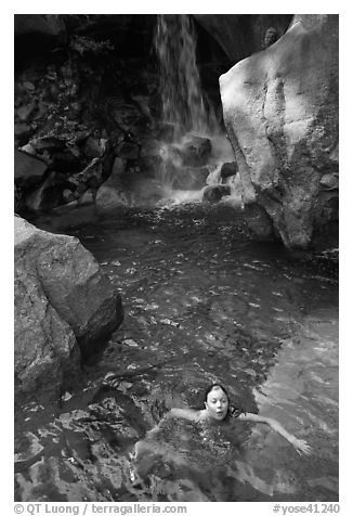 Girl swims in cool pool at the base of Wapama falls. Yosemite National Park (black and white)