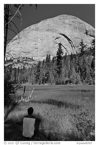 Hiker sitting at Lost Lake on west side Half-Dome. Yosemite National Park, California, USA.