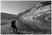 Park visitor with backpack looking, Merced Lake, morning. Yosemite National Park, California, USA. (black and white)