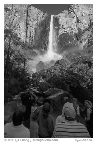 Tourists standing below Bridalvail Fall. Yosemite National Park (black and white)