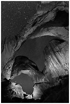 Visitor lighting up Double Arch at night. Arches National Park, Utah, USA. (black and white)