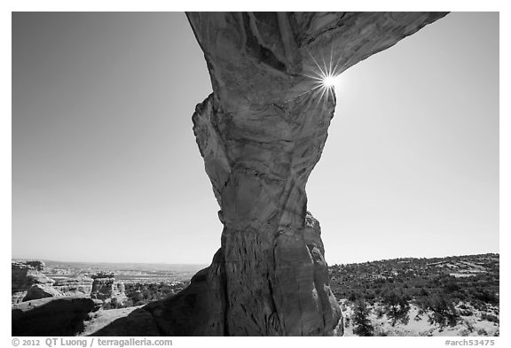 Broken Arch seen from below with sunburst at the crack. Arches National Park (black and white)