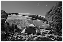 Tent with prayer flags amongst sandstone rocks. Arches National Park, Utah, USA. (black and white)
