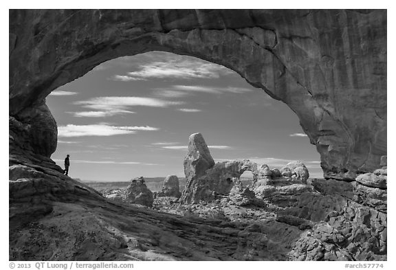 Park visitor looking, Turret Arch framed by North Window. Arches National Park (black and white)