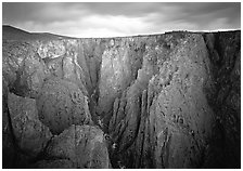 Narrow gorge under dark clouds. Black Canyon of the Gunnison National Park, Colorado, USA. (black and white)