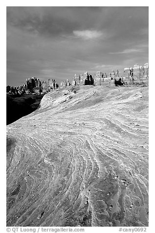 Sandstone striations and Needles near Elephant Hill, sunrise. Canyonlands National Park, Utah, USA.
