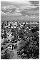 Hikers on the Chesler Park trail, the Needles. Canyonlands National Park, Utah, USA. (black and white)