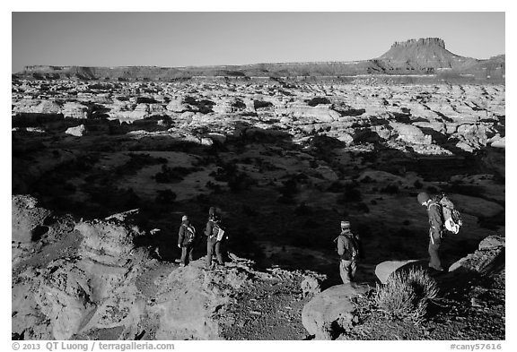 Hikers on Petes Mesa ridge above the Maze. Canyonlands National Park (black and white)