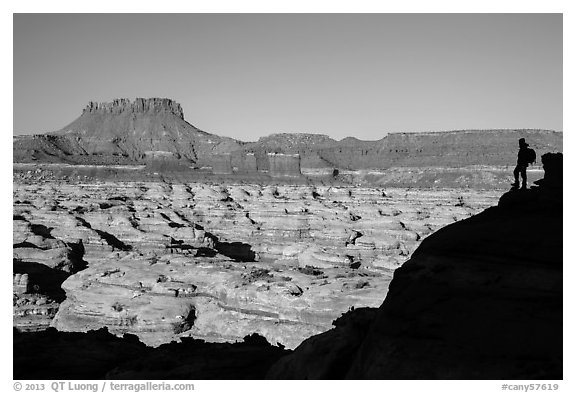 Hiker silhouette above the Maze and Chocolate drops. Canyonlands National Park, Utah, USA.