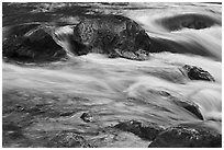 Boulders and rapids with glow from canyon walls reflected. Grand Canyon National Park ( black and white)