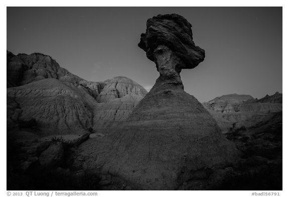 Pedestal rock at badlands at dusk. Badlands National Park, South Dakota, USA.