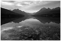 Submerged rocks and mountain reflected, Bowman Lake. Glacier National Park ( black and white)
