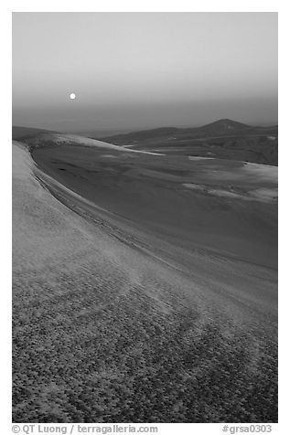 Dunes at dawn with snow and moon. Great Sand Dunes National Park, Colorado, USA.
