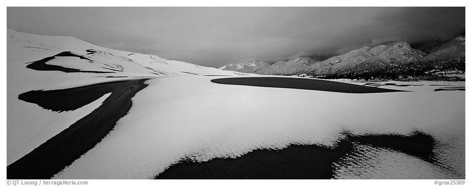 Snow-covered dune landscape and mountains at dawn. Great Sand Dunes National Park (black and white)