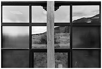 Grasslands and mountains, visitor center window reflexion. Great Sand Dunes National Park, Colorado, USA. (black and white)