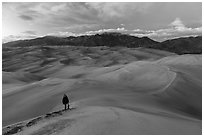 Hiker climbing high dune. Great Sand Dunes National Park, Colorado, USA. (black and white)