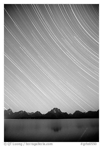 Star trails on Teton range above Jackson lake, dusk. Grand Teton National Park, Wyoming, USA.
