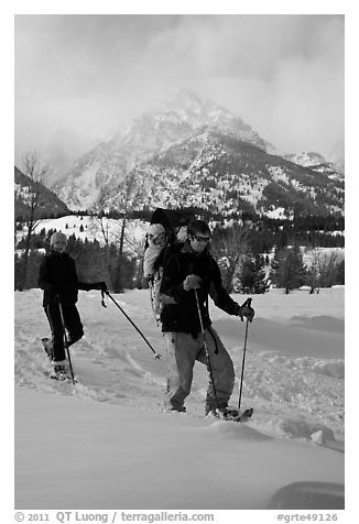 Couple snowshowing with baby. Grand Teton National Park, Wyoming, USA.