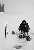Ice fisherman with lounge chair and radar,Jackson Lake. Grand Teton National Park, Wyoming, USA. (black and white)