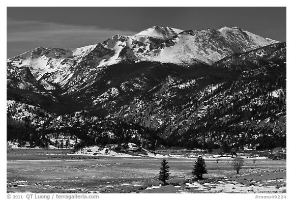 Thawing meadow and snowy peaks, late winter. Rocky Mountain National Park, Colorado, USA.
