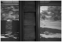 Meadow and parking lot, Medora Visitor Center window reflexion. Theodore Roosevelt National Park, North Dakota, USA. (black and white)