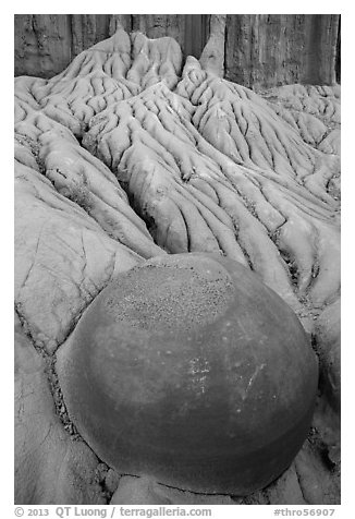 Spherical cannonball concretion in badlands. Theodore Roosevelt National Park, North Dakota, USA.