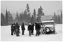 Travelers boarding snow bus. Yellowstone National Park, Wyoming, USA. (black and white)