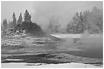 Castle geyser cone and steam in winter. Yellowstone National Park, Wyoming, USA. (black and white)