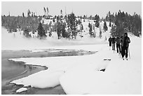 Cross country skiers pass Chromatic Spring. Yellowstone National Park, Wyoming, USA. (black and white)