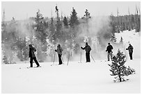 Skiers and thermal steam. Yellowstone National Park, Wyoming, USA. (black and white)