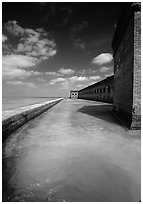 Fort Jefferson moat and massive brick wall on a sunny dayl. Dry Tortugas National Park, Florida, USA. (black and white)