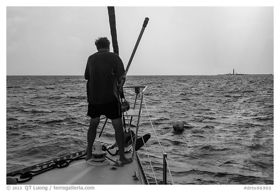 Sailor getting ready to hook mooring buoy near Loggerhead Key. Dry Tortugas National Park, Florida, USA.