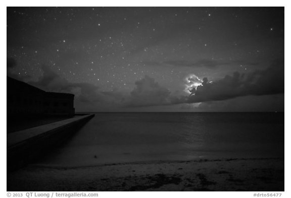 Fort Jefferson and beach at night with cloud electric storm. Dry Tortugas National Park, Florida, USA.