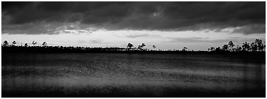 Sunset over lake with dark clouds. Everglades National Park (Panoramic black and white)