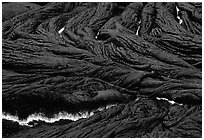 Close-up of ripples of flowing pahoehoe lava at dusk. Hawaii Volcanoes National Park, Hawaii, USA. (black and white)