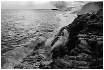 Coastline with lava entering ocean. Hawaii Volcanoes National Park, Hawaii, USA. (black and white)