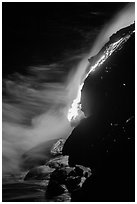 Lava flow entering Pacific Ocean at night. Hawaii Volcanoes National Park, Hawaii, USA. (black and white)