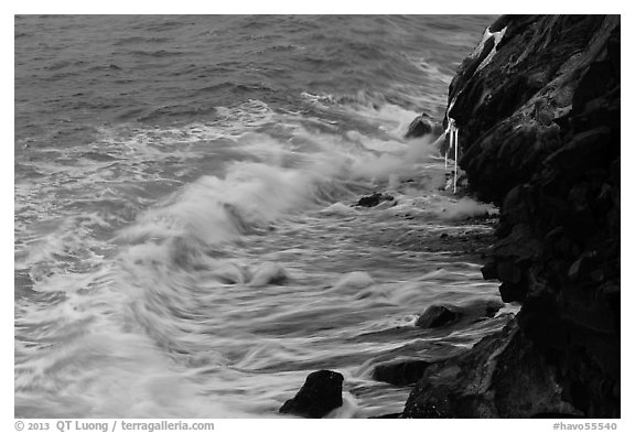 Waves and hot lava dripping from lava bench. Hawaii Volcanoes National Park (black and white)