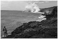 Park visitor looking, lava ocean entry plume. Hawaii Volcanoes National Park ( black and white)