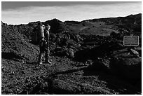 Backpacker entering park through Observatory Trail. Hawaii Volcanoes National Park, Hawaii, USA. (black and white)