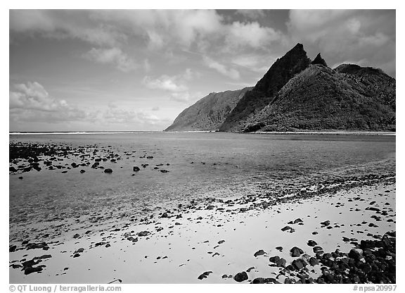 Tropical beach with sand and pebbles, and pointed peaks of Ofu Island. National Park of American Samoa (black and white)