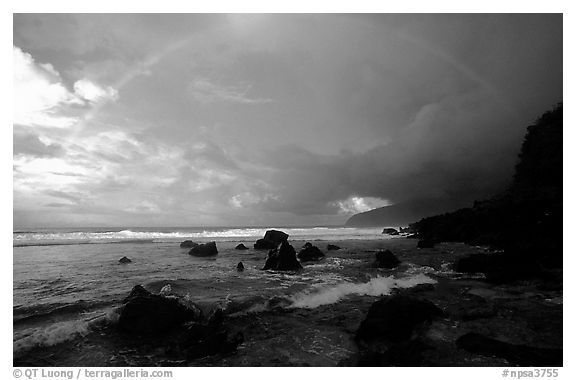 Boulders and coastline at sunrise with rainbow, Siu Point, Tau Island. National Park of American Samoa (black and white)