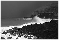 Dark boulders, crashing waves, and dark sky, storm light, Tau Island. National Park of American Samoa (black and white)